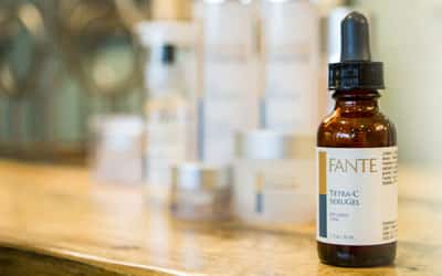 close up of beauty product on wooden table surrounded by other blurred out products