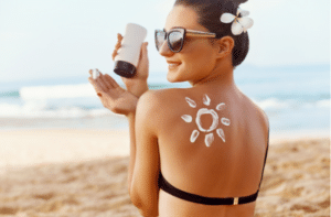 Woman Applying Sun Cream on Tanned Shoulder